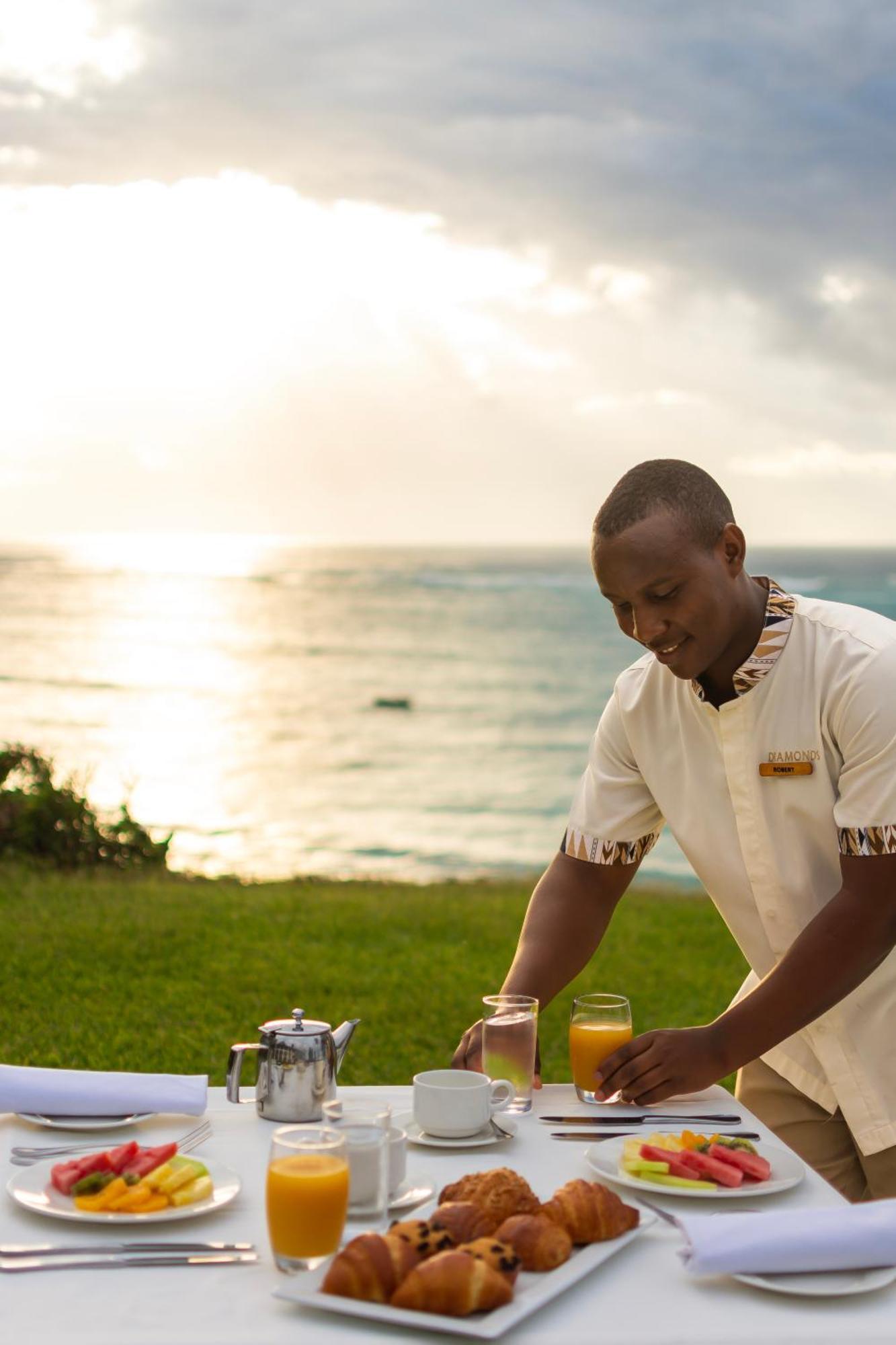 Diamonds Leisure Beach & Golf Resort Diani Beach Exterior photo A butler at work